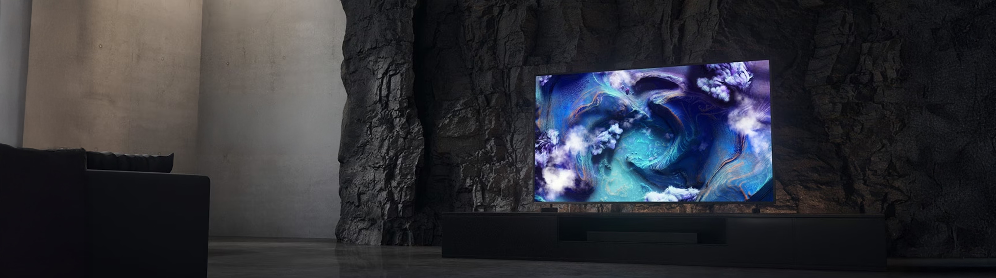 Modern flat-screen TV mounted on a stone wall in a dimly lit room