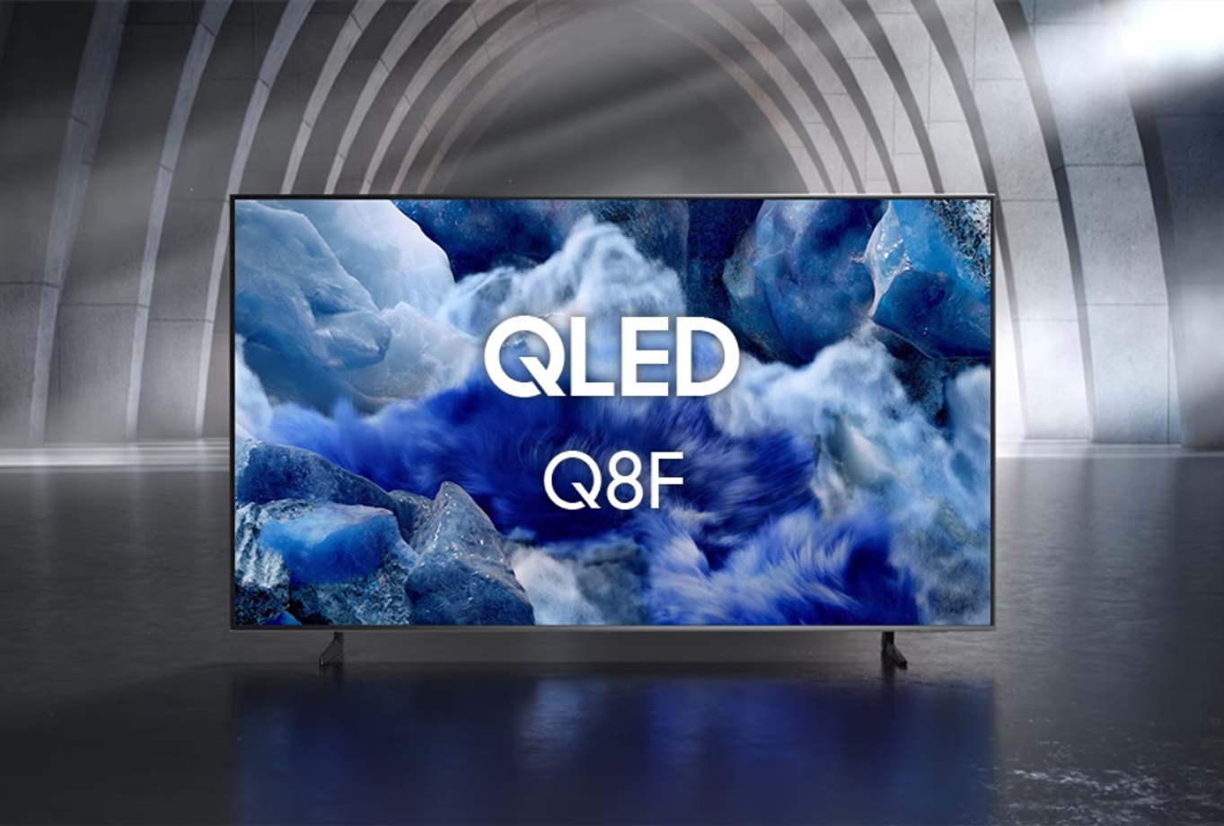 QLED TV displaying a blue and white abstract design with 'Q8F' branding.