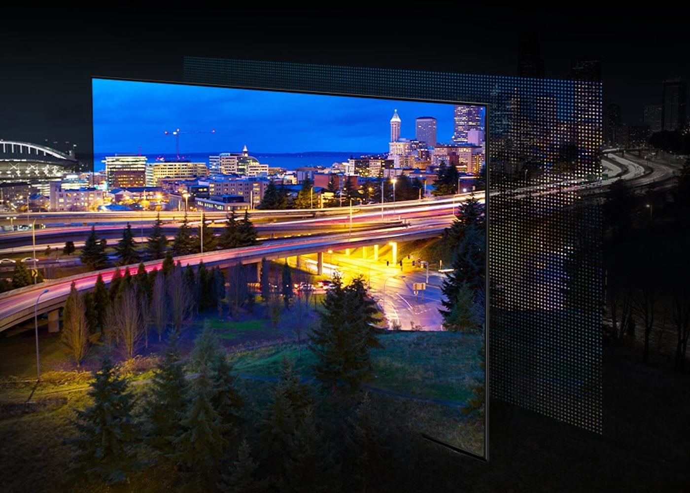Large outdoor screen displaying a cityscape at night with traffic lights.