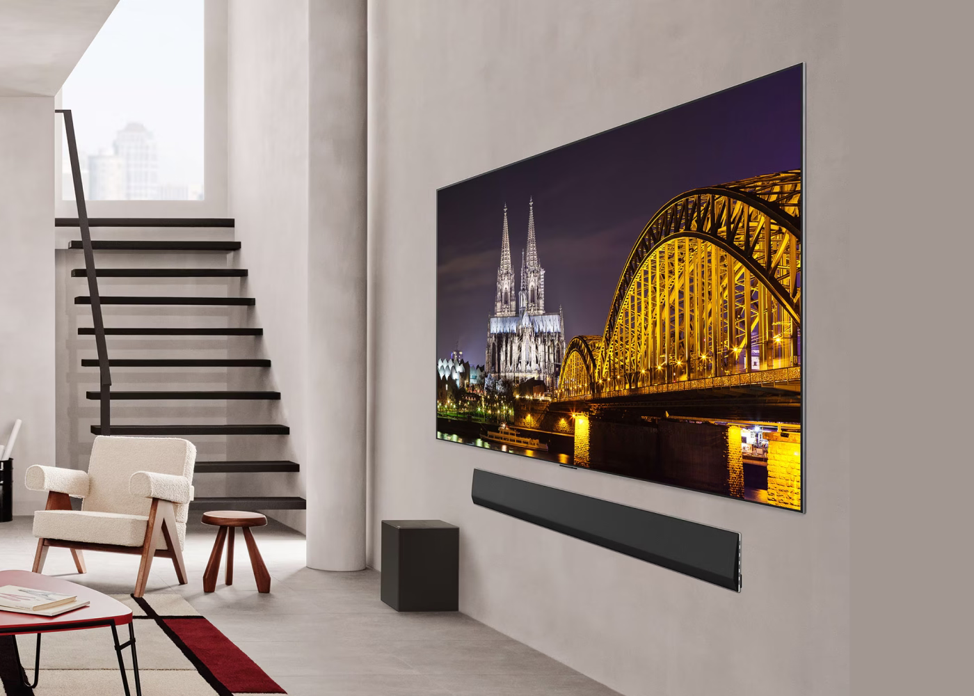 Modern living room with a large TV displaying a cityscape, surrounded by minimal decor.