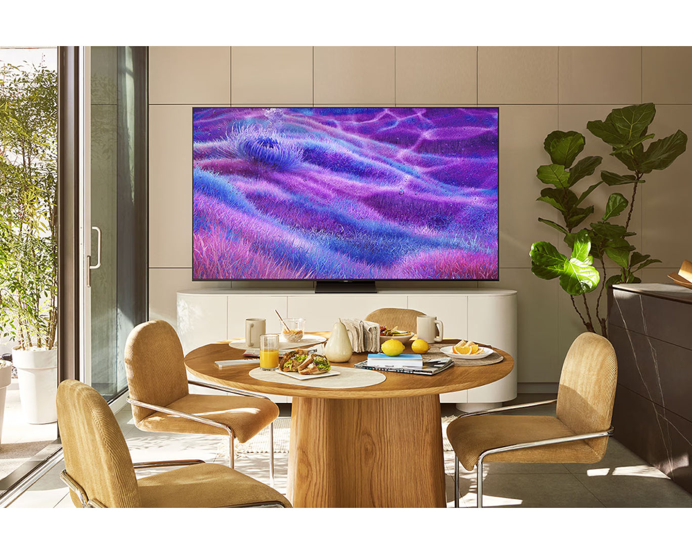 Modern dining room with a large TV displaying a colorful abstract design.