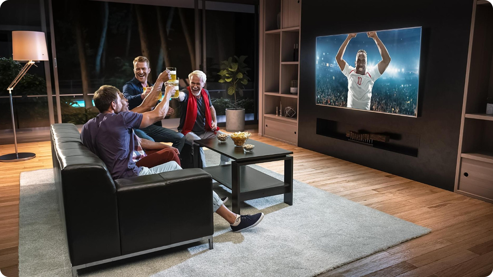 People watching a sports event on a large TV screen in a living room.