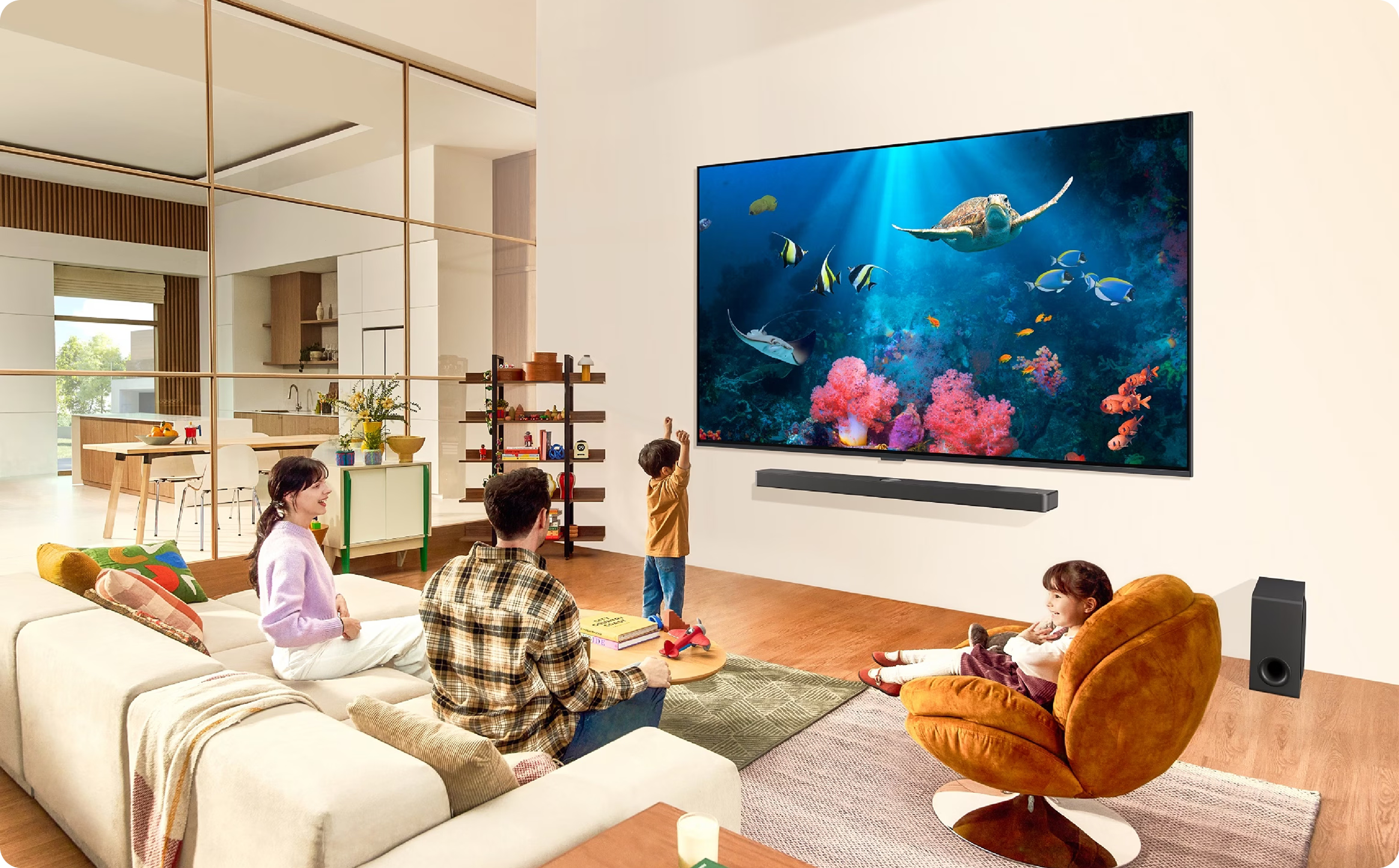 Family in a living room with a large TV displaying an underwater scene.