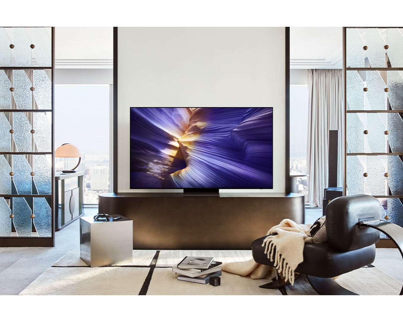 Modern living room with a large flat-screen TV displaying colorful graphics.