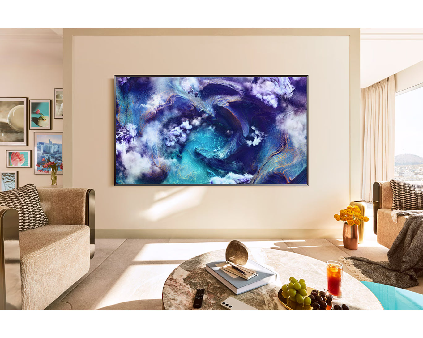 Living room with a large TV displaying an abstract art design, surrounded by furniture and decor.